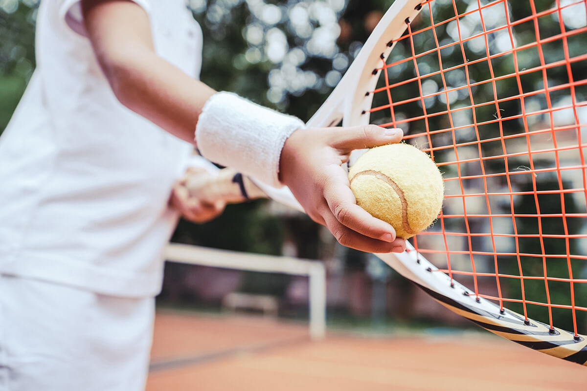 close up of tennis ball and racket