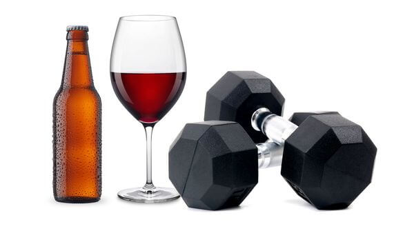 glass of wine bottle and beer and dumbells